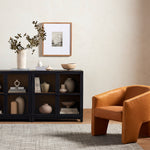Millie Small Cabinet Drifted Matte Black Next to Orange Accent Chair Four Hands