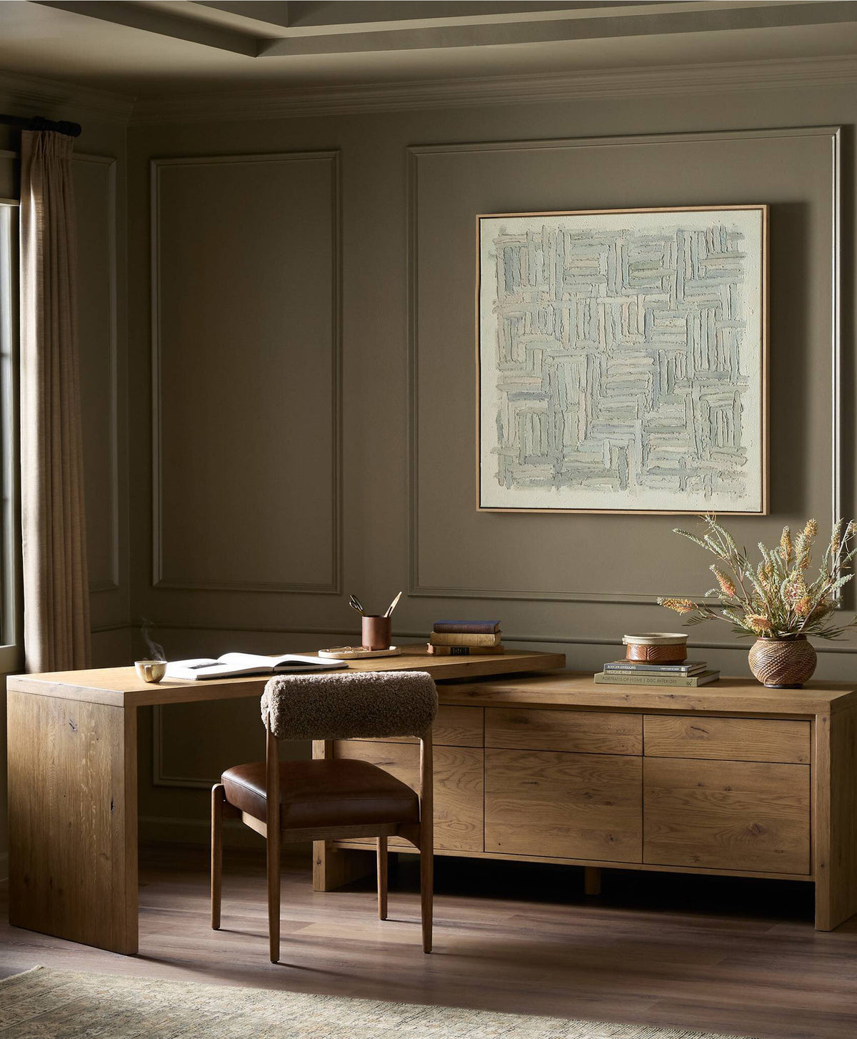 The Noah Rotating desk and Jazelle dining chair paired for a beauitful and warm home office. Items both by Four Hands furniture.