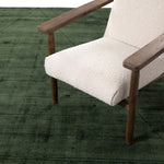 Sadzi Hand Carved 5' x 8' Rug Juniper Green Staged View with Accent Chair Four Hands