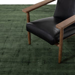 Sadzi Hand Carved 5' x 8' Rug Juniper Green Staged View with Accent Chair INOM-079-0508
