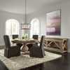 Baldwin Round Dining Table in a dining room setting with four charcoal chairs around it.