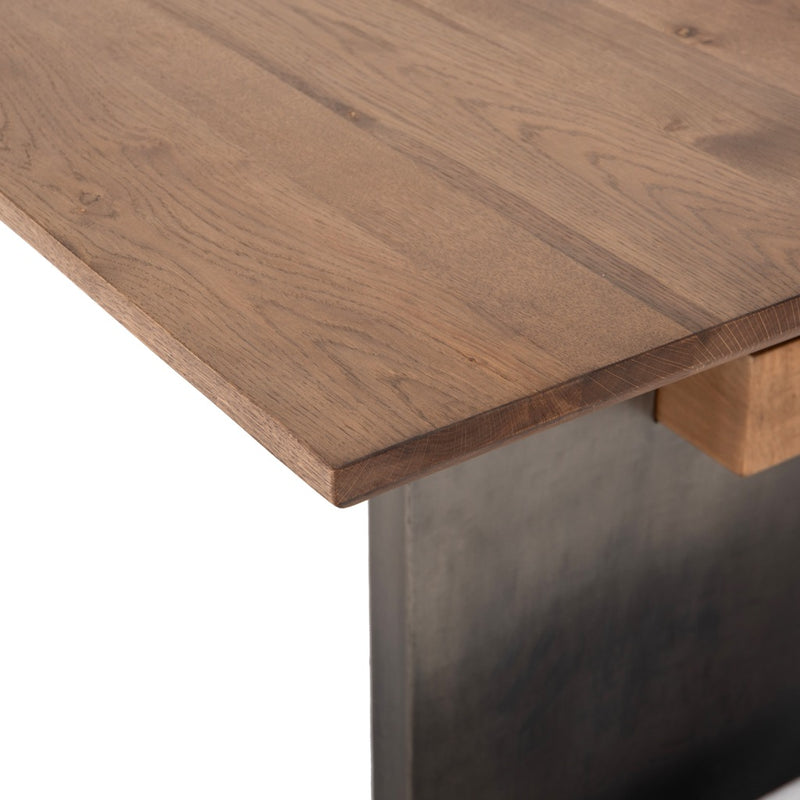 Brennan Dining Table close up view of corner tabletop and steel leg