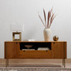 Carlisle Media Console Natural Oak Staged View with Decor Pieces on Shelving