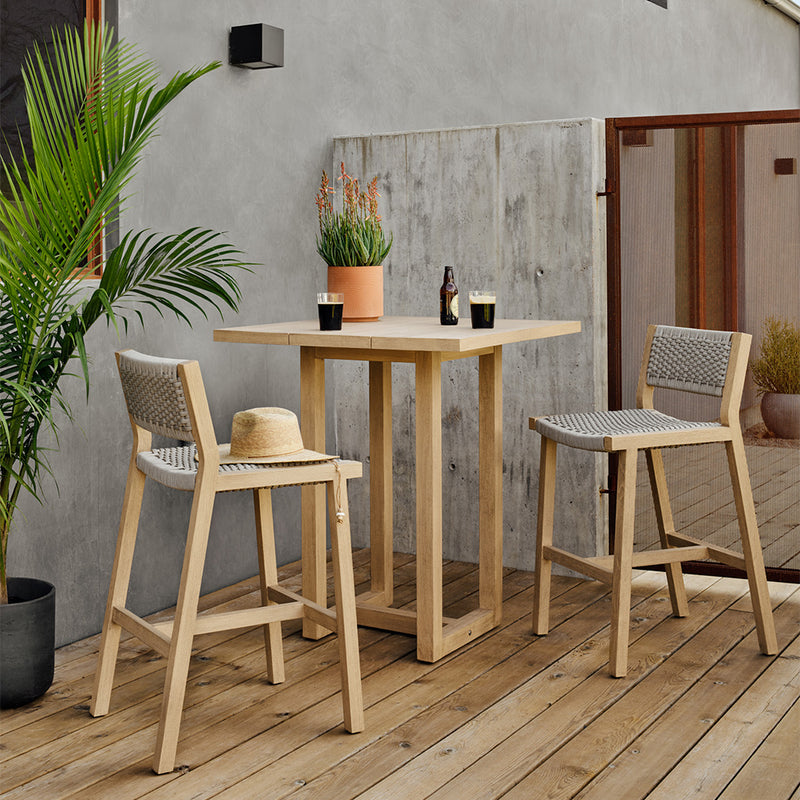 Delano Teak Outdoor Barstool Staged Image in an Outdoor Setting
