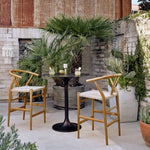 Muestra Teak Stool Natural Staged View in Outdoor Garden Setting around Bar Table 106917-010
