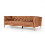 brown leather sofa with tufting